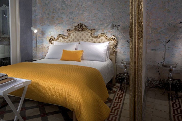 Photo © Brian Grech // Valletta SuitesIn the bedroom:silk Venetian headboard, hand carvedsilk ceiling lamp by the renowned Italian company FlosBespoke