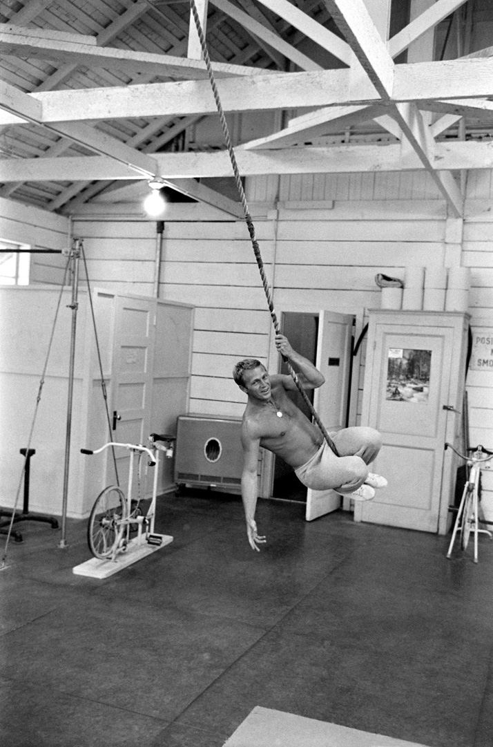 Steve McQueen: KING OF COOLSteve McQueen swinging from rope in his gym, CA, 1963photo © John Dominis / Time Inc. All Rights Reserved.