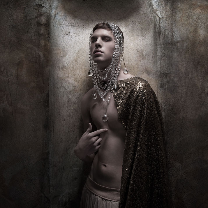 The boy KingCrystal   Necklace worn as a headpiece: Pericles Kondylatos / Model: Yarric (VN   Models) / Top worn as a cape: Kostadinos Melis by Laskos / Skirt:   celebrity skin / Make-up: Giorgos Fytas for make-up lab / Hair: Nicolas   Balalios / Photo: Sylwia Makris / Styling: Pericles Kondylatos