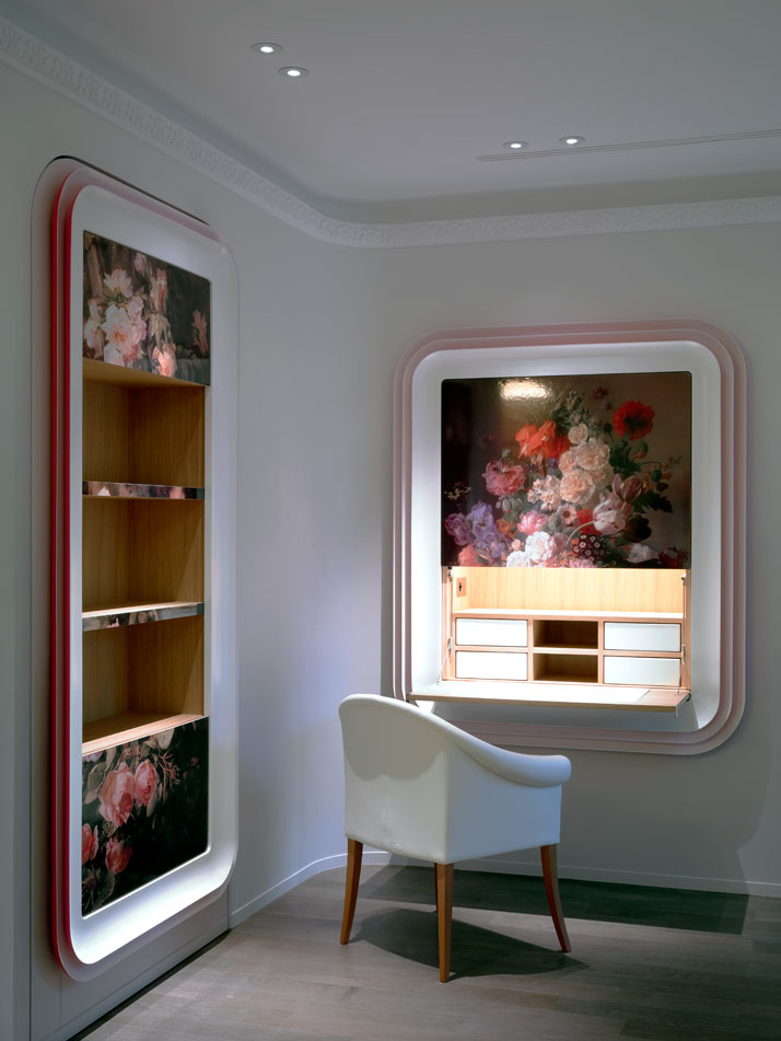 Framed  Dutch silk-screens on wood  decorate the lounge area in the guest  suite, concealing a foldable  secretary desk and a closet.Photo © Paul Graves for AD Magazine.