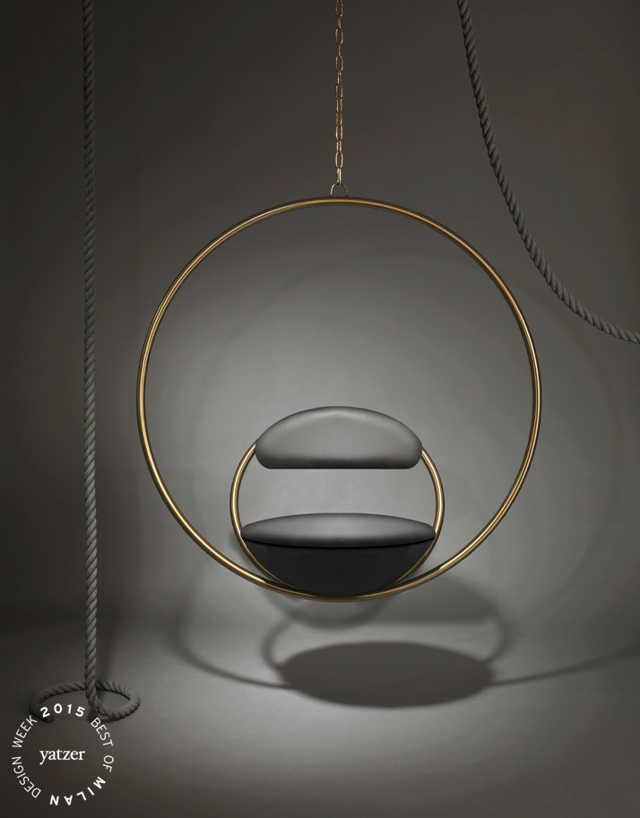 Hanging Hoop Chair by Lee Broom.Suspended from above, two circular brass-plated hoops join to create the Hanging Hoop Chair, with the seat and backrest upholstered in Kvadrat wool.