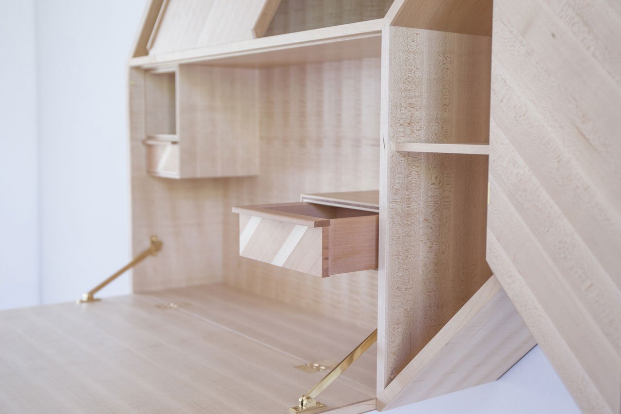Facet by Kunsik, a wall mounted cabinet which can be used both as a storage and a writing desk.