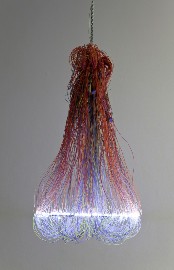 Wire Chandelier // Rainbow ribbon cable lights up. 300 individual hand soldered resin covered LEDs light up this chandelier. The color coded electrica