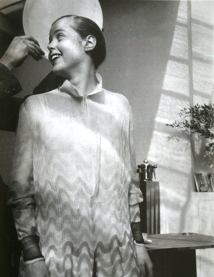 Charlotte Perriand with Le Corbusier's hand, holding a plate by way of a halo, 1928. Source TheRedlist.