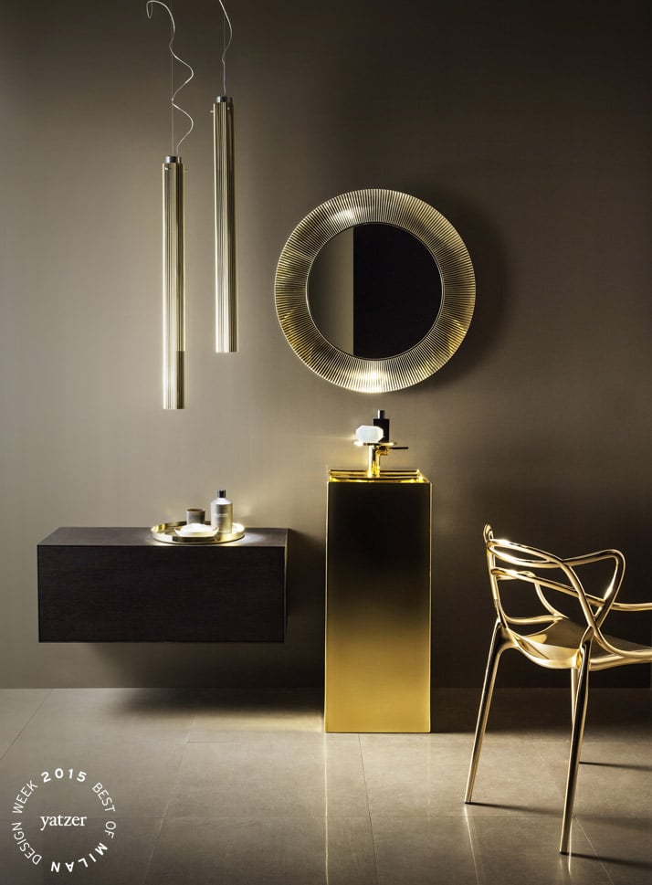 KARTELL by LAUFEN collection by Ludovica+Roberto Palomba.Freestanding washbasin, 37,5x43,5xh90 cm, with special hidden outlet, made of Fine Fire Clay in customized gold glazing. Washbasin mixer disc, fixed spout 11 cm, without pop-up waste.  Polycarbonate ALL SAINTS mirror, diam. 78 cm in gold colour.  Wall cabinet with push and pull drawer from the collection BOUTIQUE. Couple of polycarbonate pendant RIFLY lamps diam 8 cm, h 90 cm in gold colour with plisse’ effect.