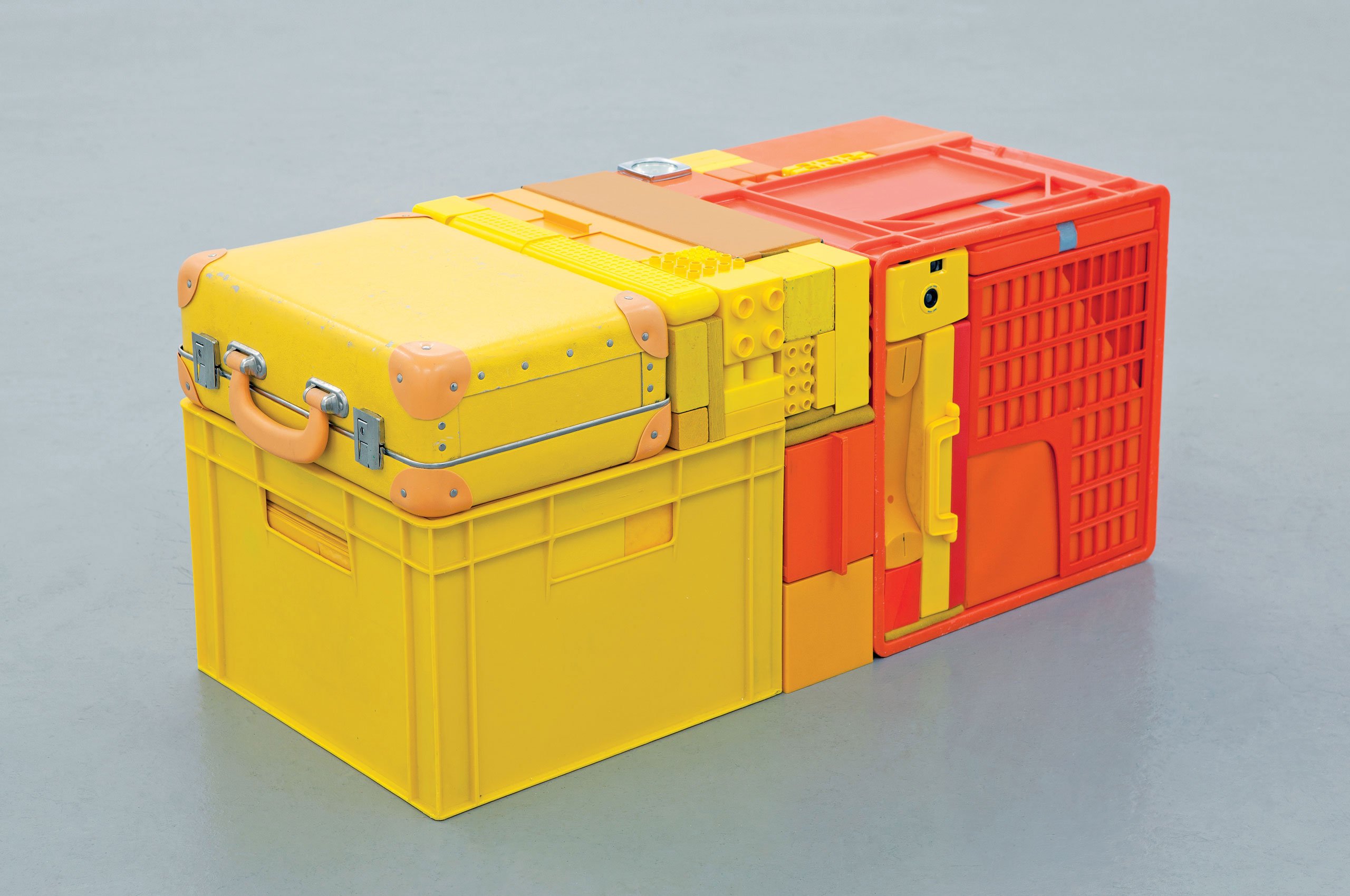 TUBE by Michael Johansson 2013, 36 × 36 × 81 cm Yellow and orange bags, boxes, and ordinary items. Courtesy of Tom Buchanan and 8 Books.