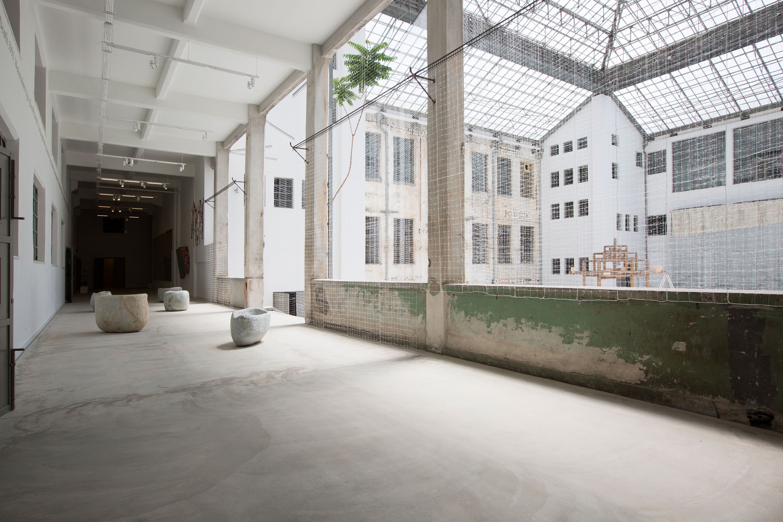 Installation View Portals, Hellenic Parliament + NEON at the former Public Tobacco Factory, Photography © Natalia Tsoukala. Courtesy NEON
Featured (from left):
Solange Pessoa, Untitled, 2013. Soapstone. Courtesy the artist and Mendes Wood DM São Paulo, New York, Brussels.
Maria Loizidou, A Monumental Lightness, 2021. Cotton, linen, silk threads and metal. 12.20 × 19.80 × 7.80 m. Courtesy the artist and Kalfayan Galleries, Athens - Thessaloniki Commissioned by NEON.