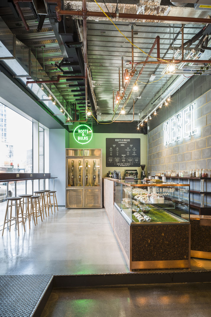 In the reception area, healthy food and freshly-pressed juices are served by Roots &amp; Bulbs juice bar. The bar area was designed by k-studio. Photo by Gareth Gardner.