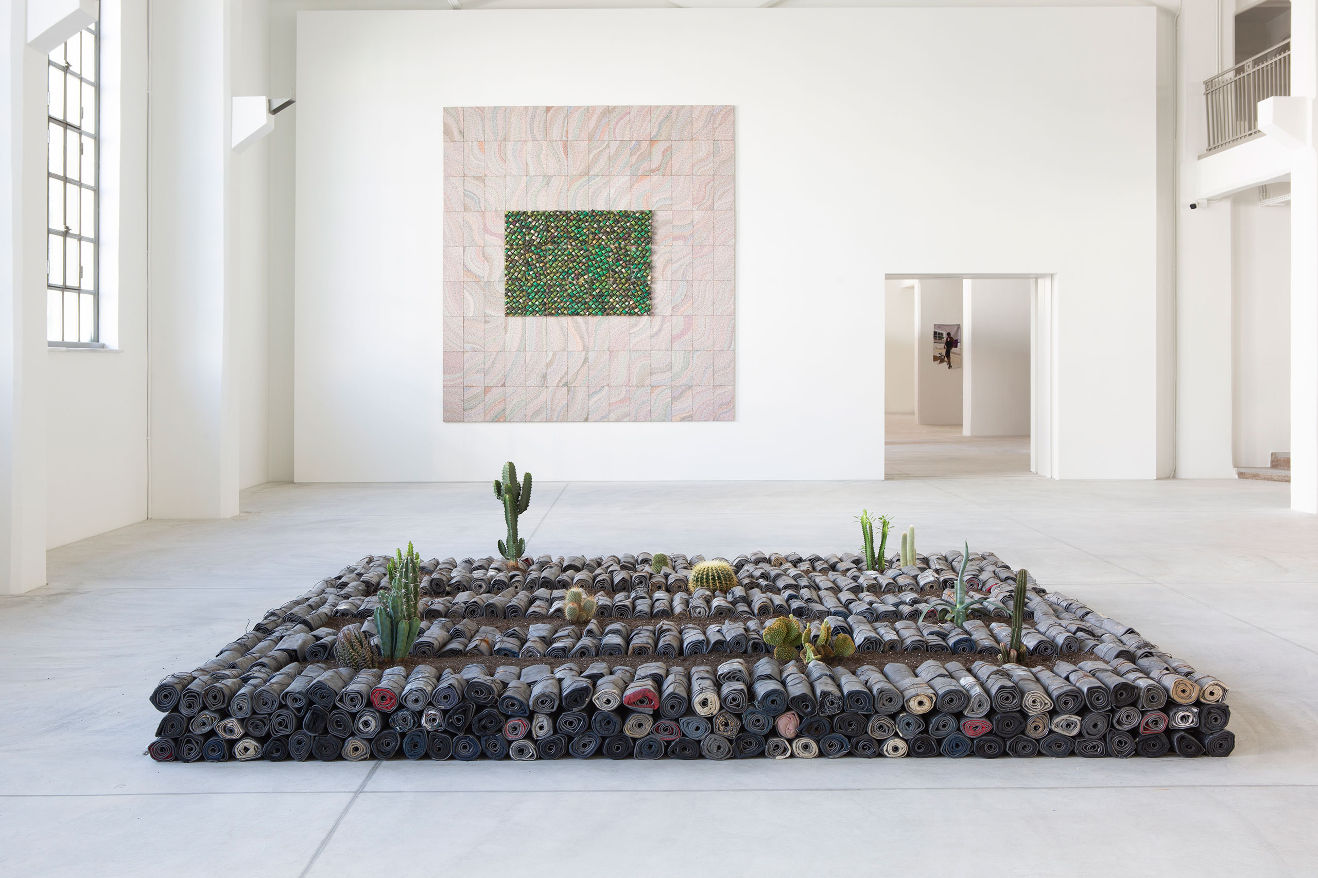 Installation View Portals, Hellenic Parliament + NEON at the former Public Tobacco Factory, Photography © Natalia Tsoukala. Courtesy NEON
Featured (front to back):
Jannis Kounellis, Untitled, 2005. Lead, clothes, earth, cacti. 85 × 360 × 360 cm. Private Collection Rome, Italy.
Elias Sime, TIGHTROPE: ECHO!?, 2020. Reclaimed electrical wire and components. 365.8 × 320 × 3.2 cm. Courtesy the artist and James Cohan, New York.