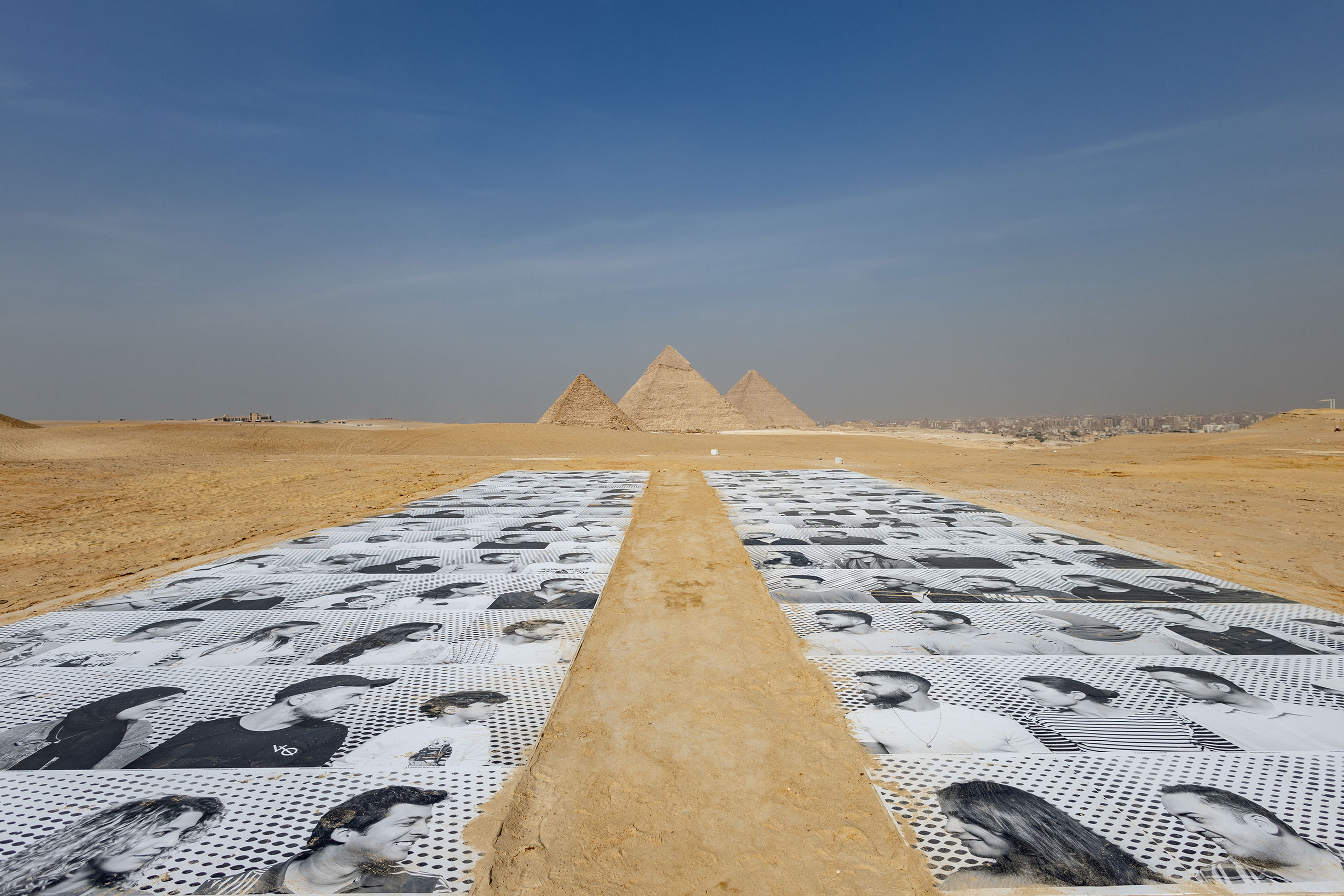 "Inside Out Giza 2022 - 2023" by JR. Installation view, “Forever Is Now III”, Art D’Egypte. © AFP