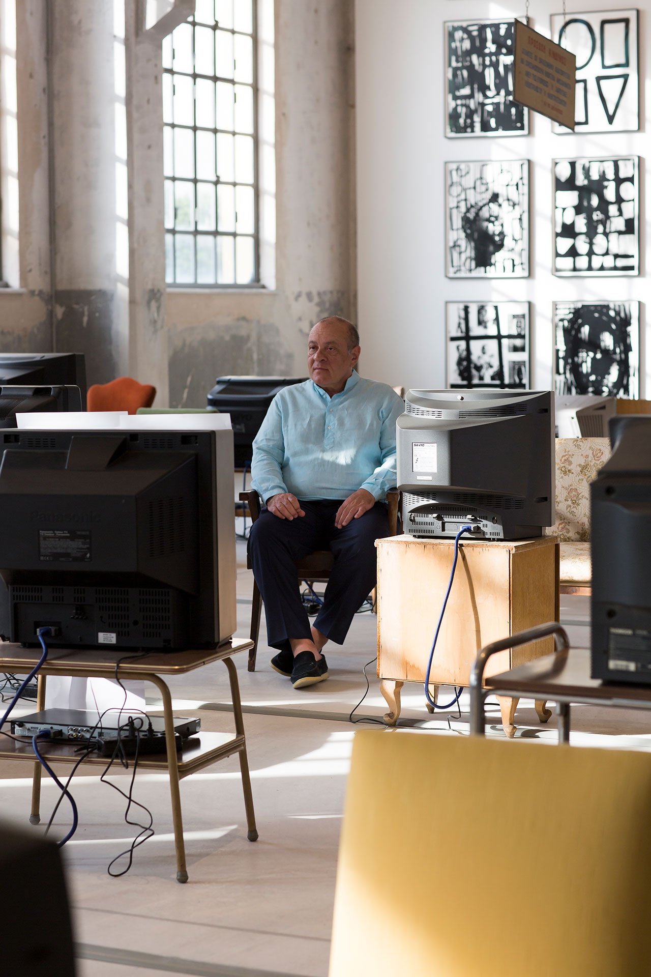 Installation View Portals, Hellenic Parliament + NEON at the former Public Tobacco Factory, Photography © Natalia Tsoukala. Courtesy NEON
Featured:
Dimitris Daskalopoulos, ΝΕΟΝ Founder.
Kutluğ Ataman, Küba, 2004. 40 channel video installation with sound, 40 used chairs, 40 tables, 40 television sets. Dimensions variable. D.Daskalopoulos Collection.
Adam Pendleton, Our Ideas #2, 2018. Silkscreen ink on Mylar. Overall installation dimensions variable. 32 panels, 102.6 cm × 79.7 cm each, artist's frames. Courtesy of Yaacov Gorsd Collection. Art Consultancy Idit Orni