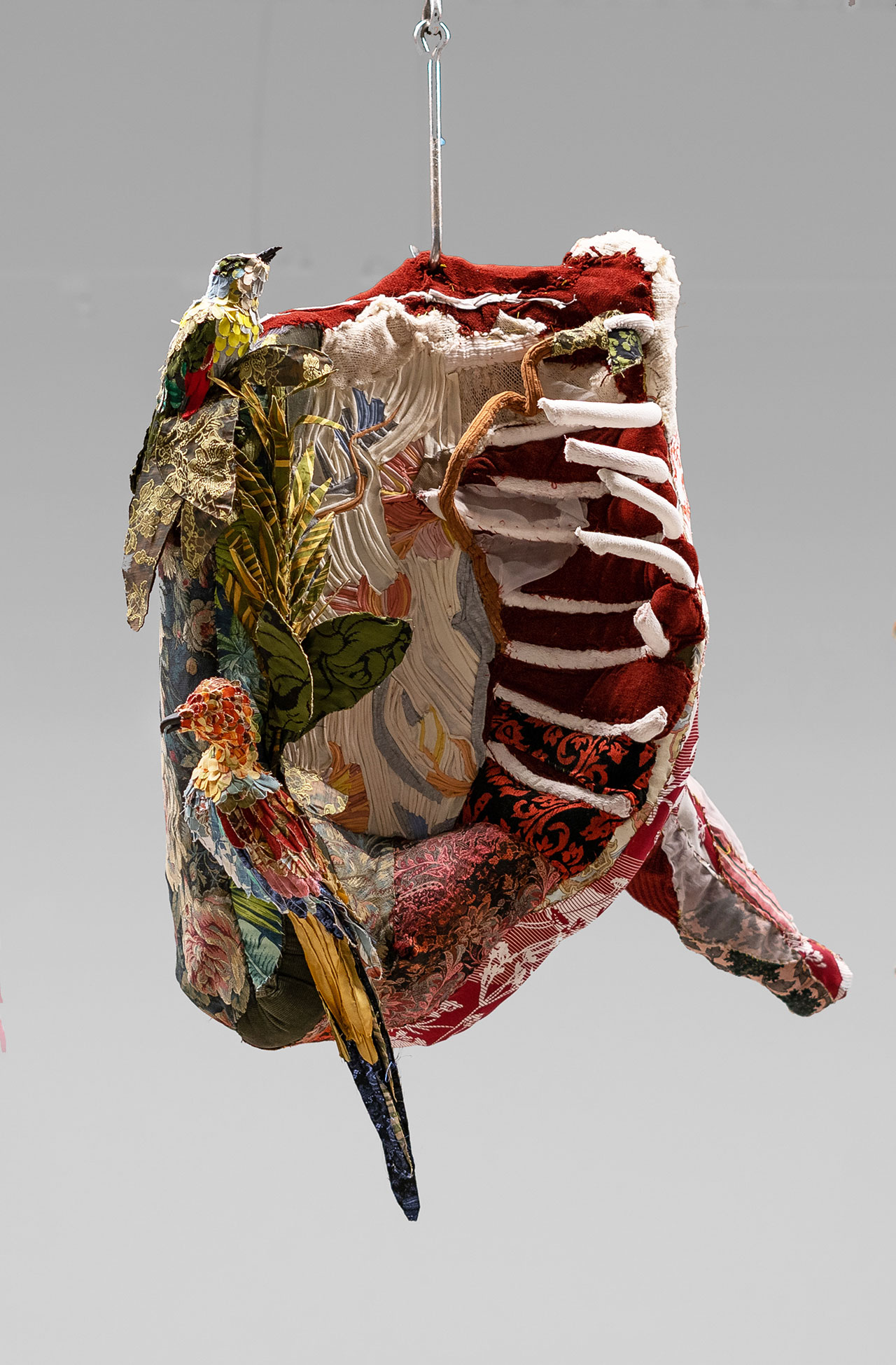 Tamara Kostianovsky, Half Cow with Tropicalia,  2022. Recycled Upholstery fabrics and other Textiles, Acrylic Nails, Meat. Courtesy OCA, Slag Gallery and the artist.