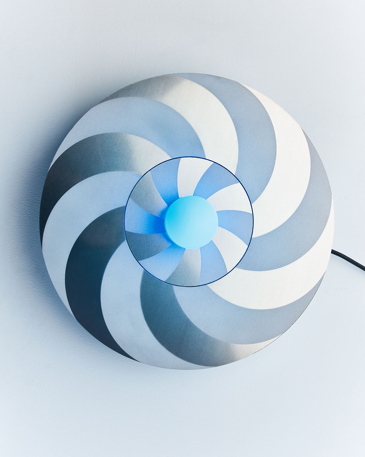 Vertigo.
Materials: aluminium, sandblasted glass globe, G4 blue LED nugget, printed technical parts, mechanical transmission systems, ball bearings, motor and electronic cards, converter (dimmable light).  
Dimensions: Ø47 x 15cm 
Photography by Stanislas Huaux &amp; Jeremy Marchant.
© Studio Élémentaires
