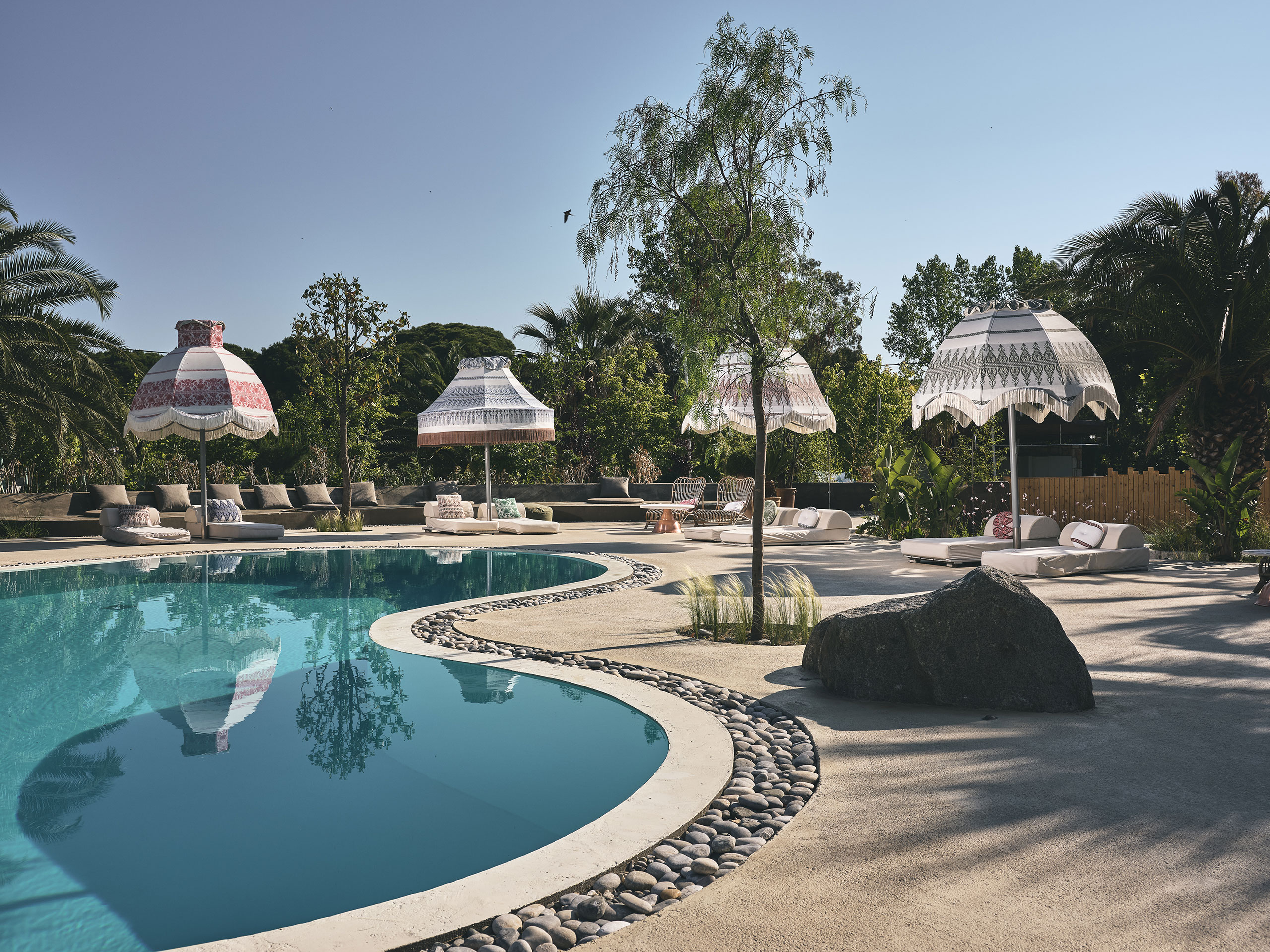 Hidden by lush vegetation, the resort’s large pool is an oasis of peacefulness. © Ekies All Senses Resort | Vourvourou, Halkidiki, Greece.