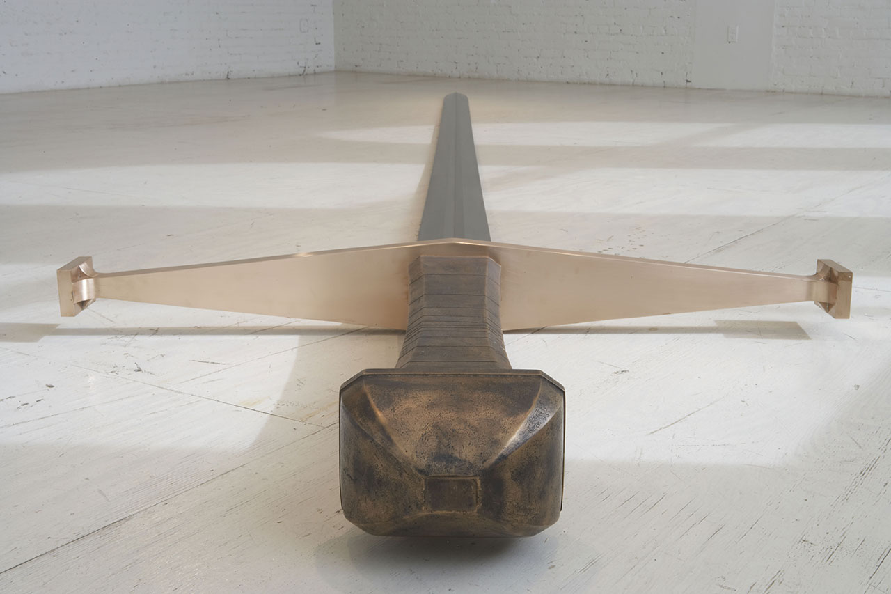 Kris Martin, Mandi XV, 2007. Steel, bronze. Installation view MOMA PS1. Photo by Matthew Septimus.
Artist's statement: This perfectly functional sword is too large for a man. Who is it for?