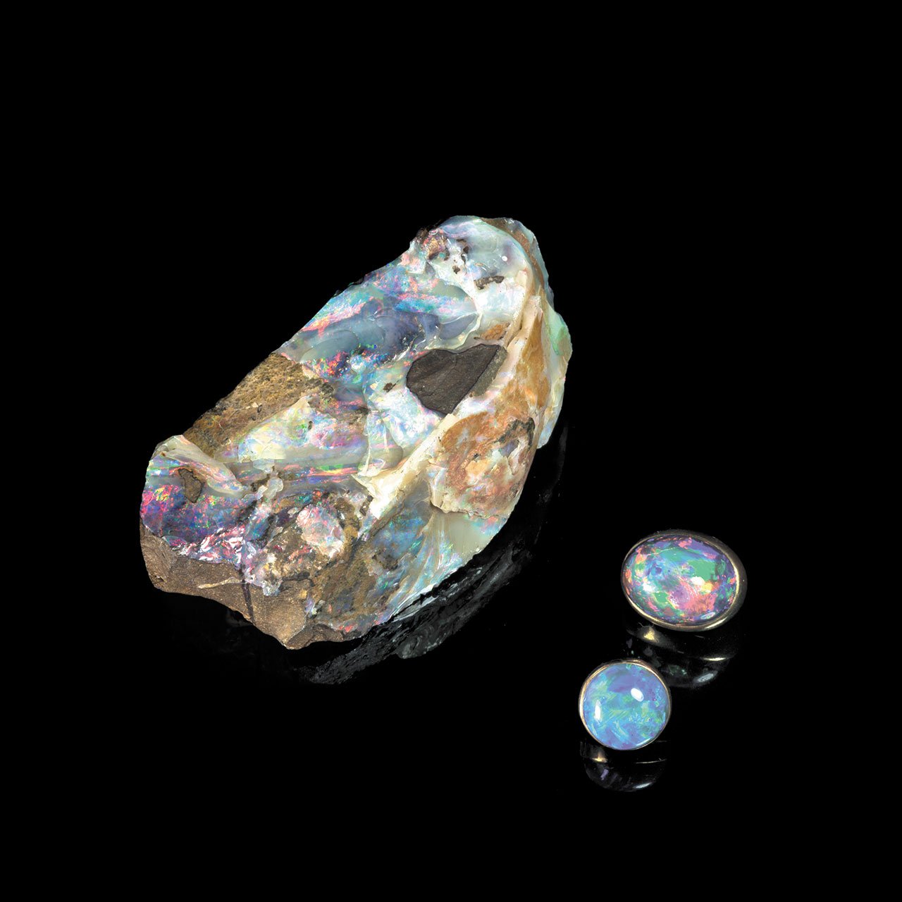 White noble opal massive and two cabochons. Queensland, Australia. MNHN Collection, Paris © MNHN/F. Farges.