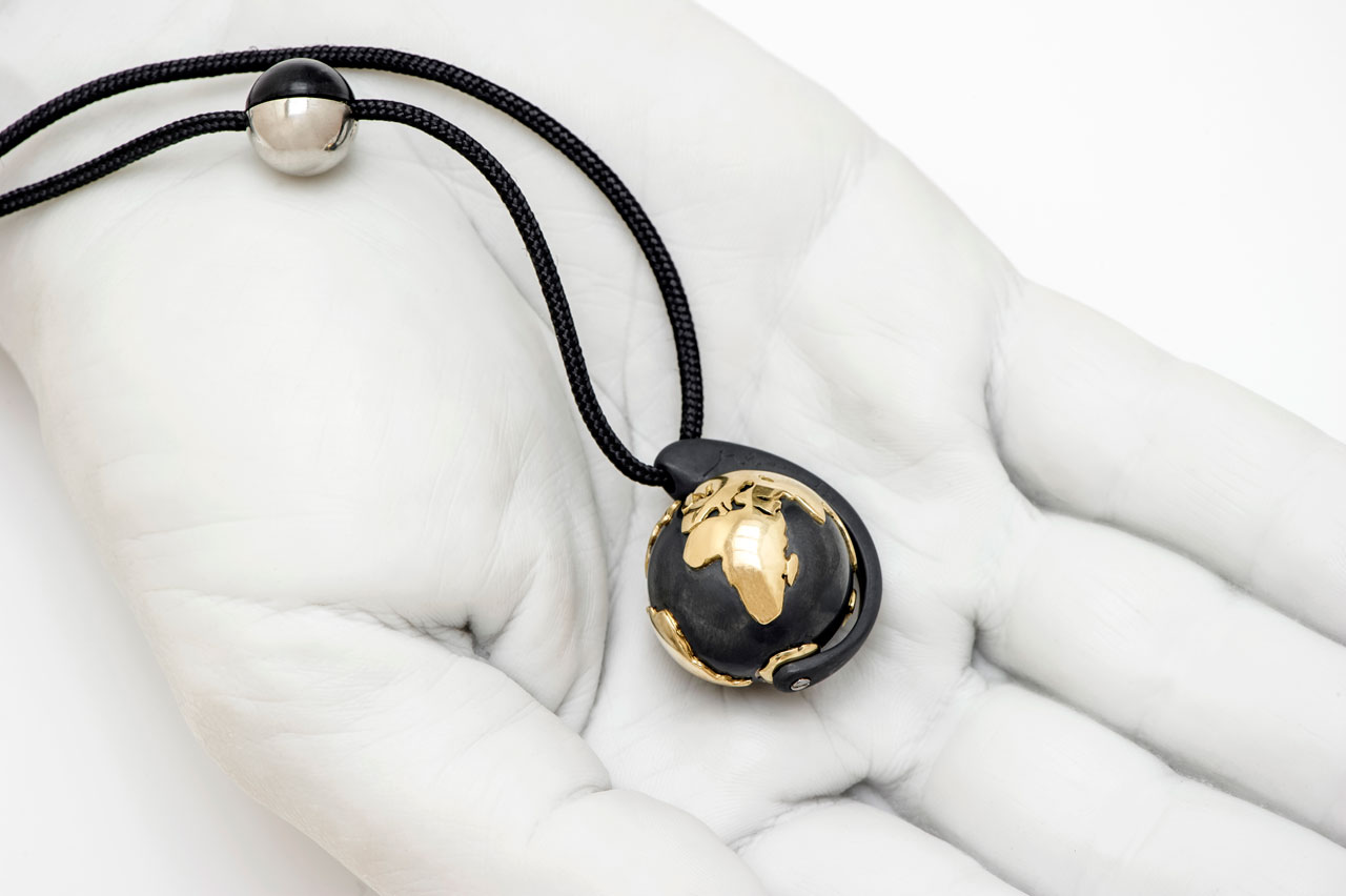 no.13 Earth &amp; Moon pendant by Minas / Gold, oxidized silver, platinum, rubber on a black cord  / earth: 25 mm / moon: 12 mm (half rubber, half platinum) / Edition of 1. Styling by Costas Voyatzis, photo by Fabrizio Annibali.