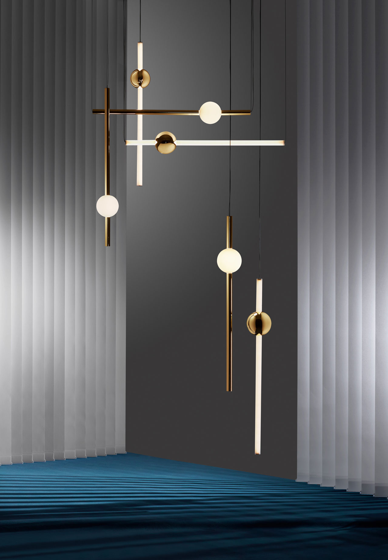 Orion by LEE BROOM comprises simple modular tube lights with opposing opaque and solid polished gold spheres which connect and expand horizontally and vertically to create bespoke constellations of light.