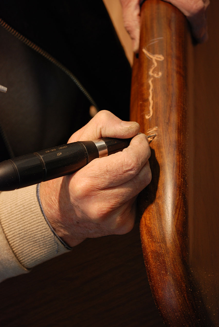 Minas hand engraving a table top. 
Photo by Alexandros Botonakis.